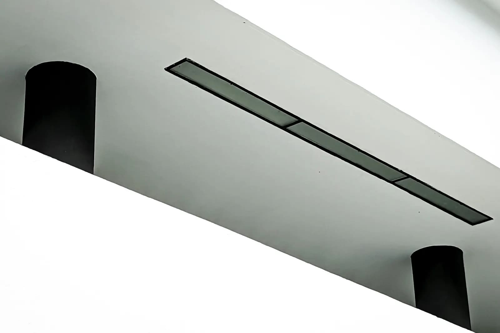 Difusor lineal de aire acondicionado integrado de forma discreta en un techo blanco